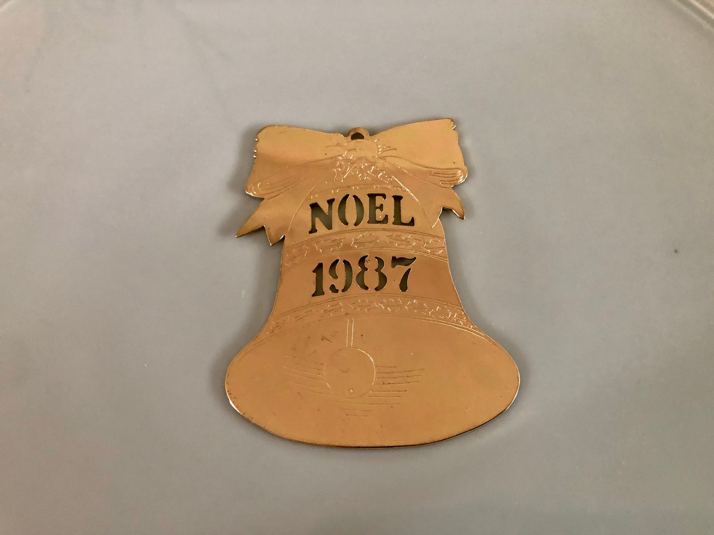 Gold, Noel 1987 Bell Cut Metal Christmas Ornament, USA Holiday Brass, Bell with Bow